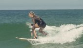 Maud Le Car surfs in heels and dress (video)
