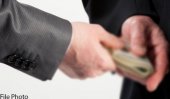 Top policeman bribes police commission member?